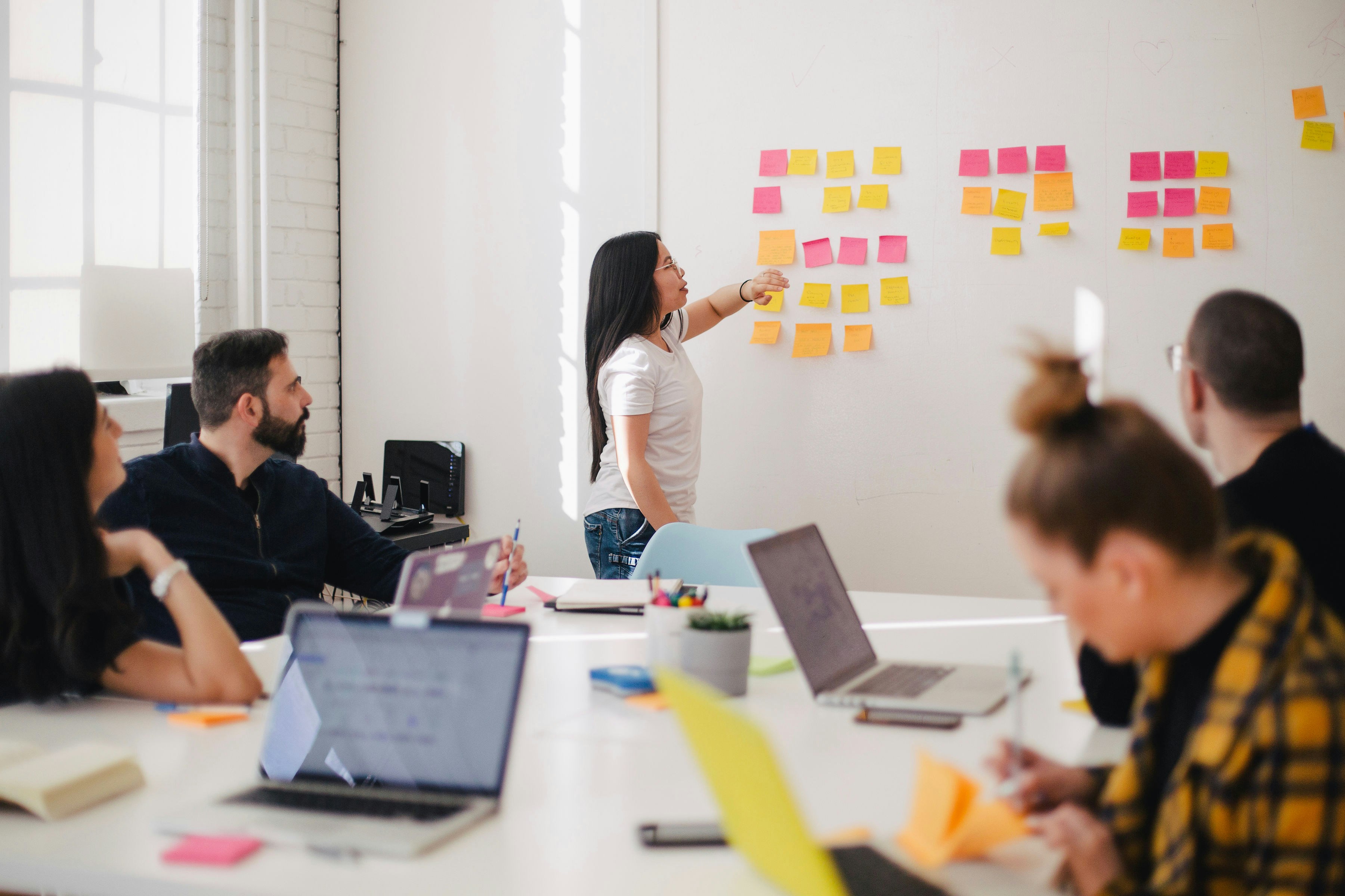 A diverse team of professionals collaborating around a table, planning a project strategy.